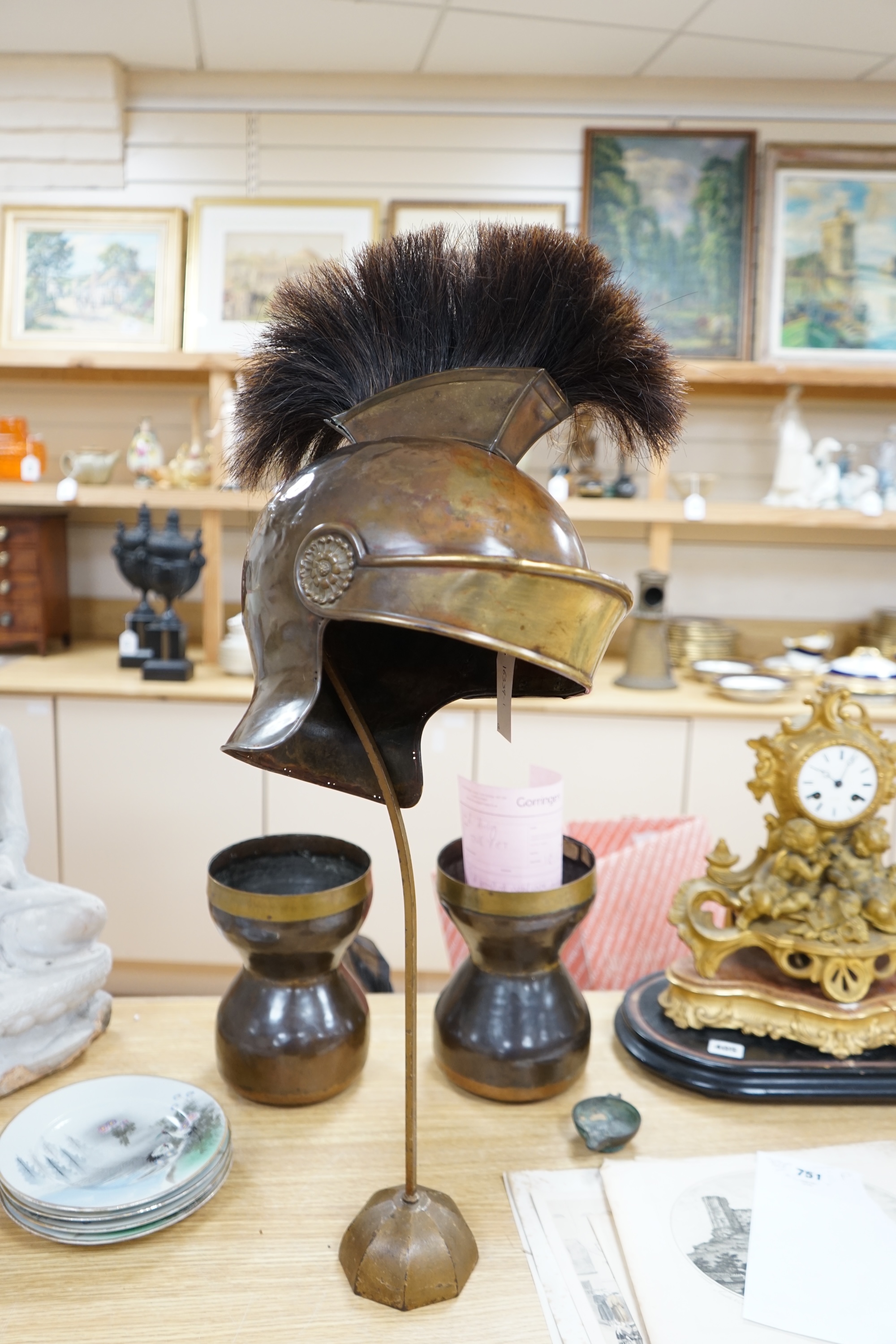 A group of metalware including a Roman style theatrical helmet on stand, a pair of vases and an oil lamp filler, largest 75cm high. Condition - fair to good, lamp filler in antique condition